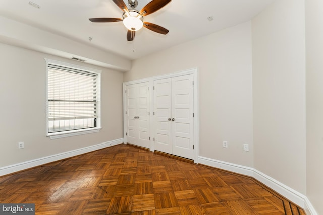 1419 Clifton St NW Unit 101, Washington, DC 20009 - unfurnished bedroom with baseboards, two closets, and ceiling fan
