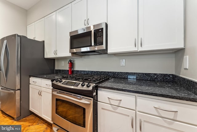 1419 Clifton St NW Unit 101, Washington, DC 20009 - kitchen featuring stainless steel appliances, white cabinets, and dark stone countertops