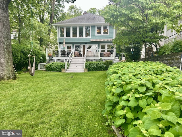 569 Highbank Rd, Severna Park, MD 21146 - back of property with stairway, a wooden deck, roof with shingles, a yard, and a chimney