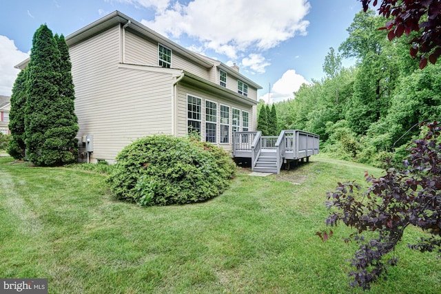 857 Barcelona St, Townsend, DE 19734 - rear view of property featuring a lawn, a deck, and a chimney