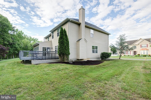 857 Barcelona St, Townsend, DE 19734 - view of side of property with a chimney, a wooden deck, and a lawn