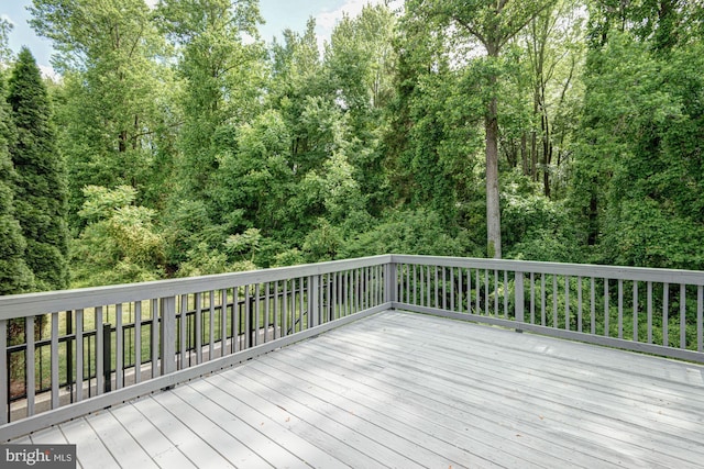 857 Barcelona St, Townsend, DE 19734 - wooden terrace featuring a view of trees