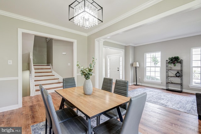 857 Barcelona St, Townsend, DE 19734 - dining room with stairway, ornamental molding, wood finished floors, a chandelier, and baseboards