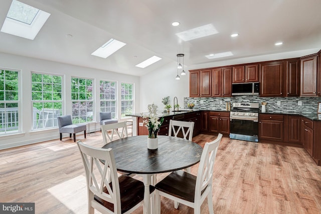 857 Barcelona St, Townsend, DE 19734 - kitchen with stainless steel appliances, a skylight, a sink, lofted ceiling, and backsplash