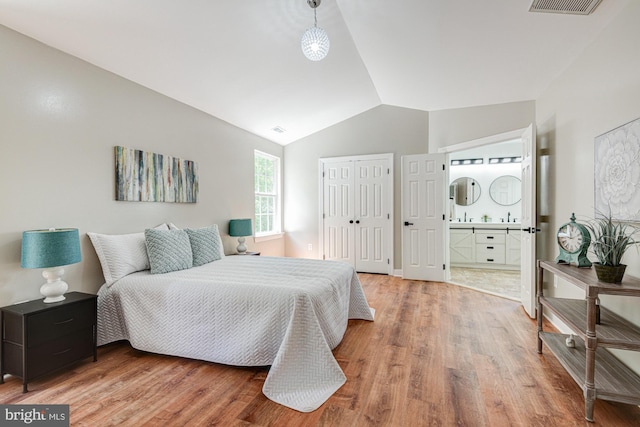 857 Barcelona St, Townsend, DE 19734 - bedroom featuring light wood-type flooring, vaulted ceiling, connected bathroom, and a closet