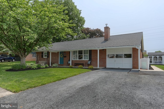 1138 S Green St, Palmyra, PA 17078 - ranch-style home featuring an attached garage, brick siding, a chimney, driveway, and a front yard