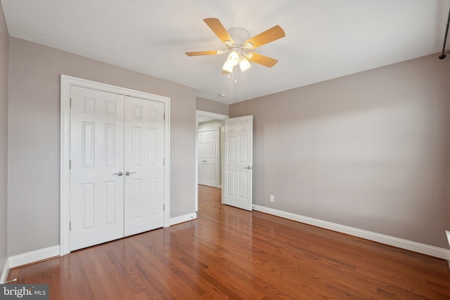20677 Erskine Ter, Ashburn, VA 20147 - unfurnished bedroom featuring baseboards, wood finished floors, a closet, and a ceiling fan