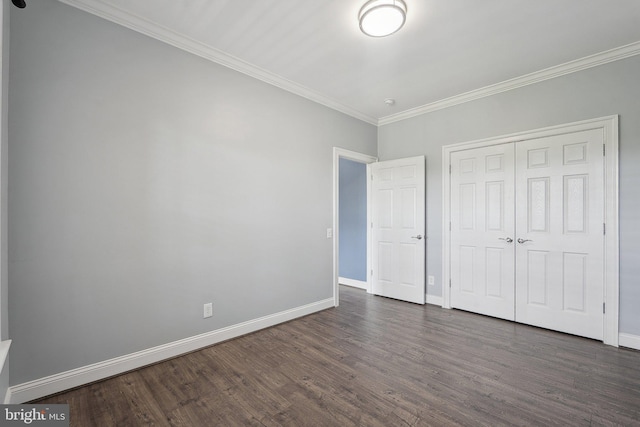 20677 Erskine Ter, Ashburn, VA 20147 - unfurnished bedroom featuring dark wood finished floors, ornamental molding, baseboards, and a closet
