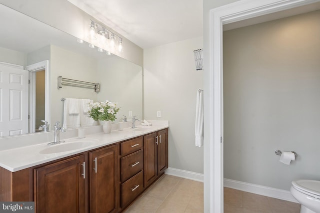 20677 Erskine Ter, Ashburn, VA 20147 - bathroom featuring double vanity, toilet, tile patterned flooring, and baseboards