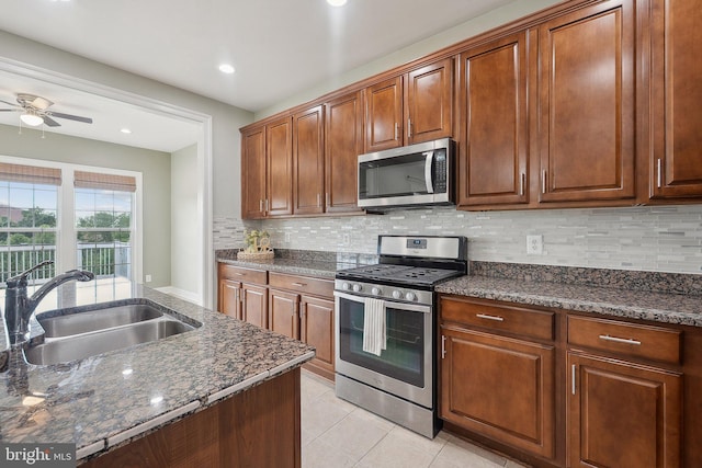 20677 Erskine Ter, Ashburn, VA 20147 - kitchen with appliances with stainless steel finishes, a sink, backsplash, ceiling fan, and light tile patterned floors