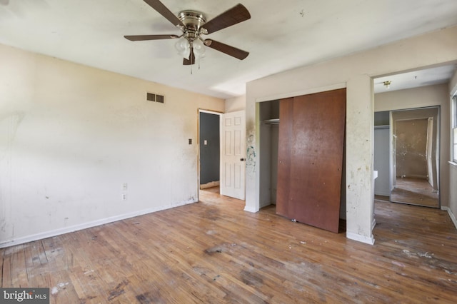 116 Layton Dr, New Castle, DE 19720 - unfurnished bedroom featuring hardwood / wood-style flooring, a closet, baseboards, and a ceiling fan