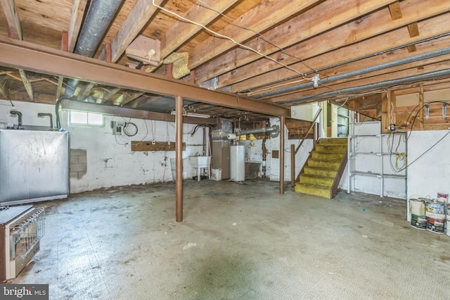 116 Layton Dr, New Castle, DE 19720 - below grade area featuring water heater, stairway, and a sink