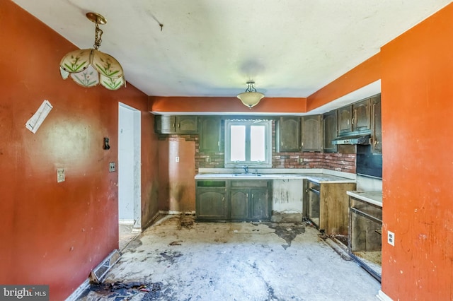 116 Layton Dr, New Castle, DE 19720 - kitchen with under cabinet range hood, a sink, light countertops, green cabinetry, and tasteful backsplash