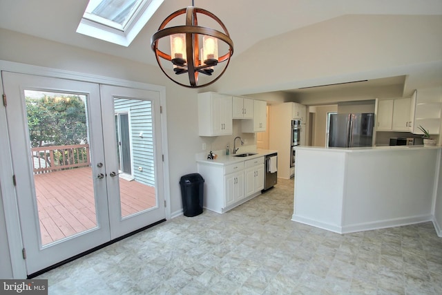 813 Pointer Ridge Dr, Gaithersburg, MD 20878 - kitchen featuring appliances with stainless steel finishes, a chandelier, a skylight, french doors, and lofted ceiling