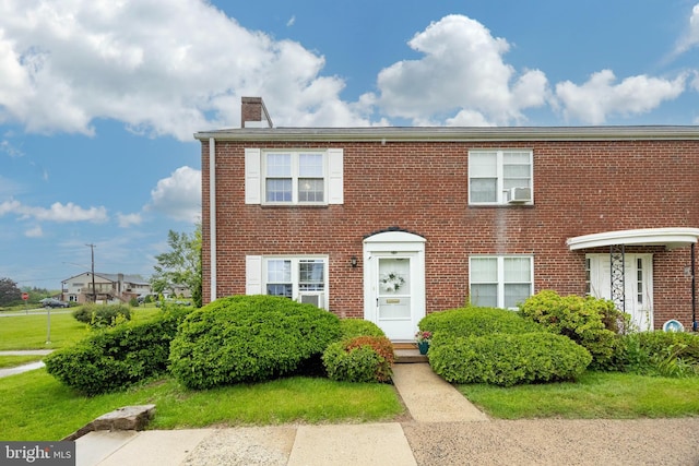 200 Maplewood Dr Unit 20, Pottstown, PA 19464 - view of front facade featuring a chimney, brick siding, and cooling unit
