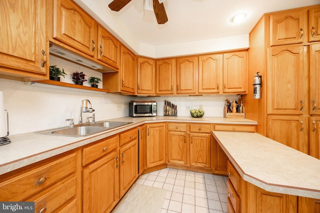 200 Maplewood Dr Unit 20, Pottstown, PA 19464 - kitchen featuring a sink, stainless steel microwave, light countertops, tasteful backsplash, and a ceiling fan