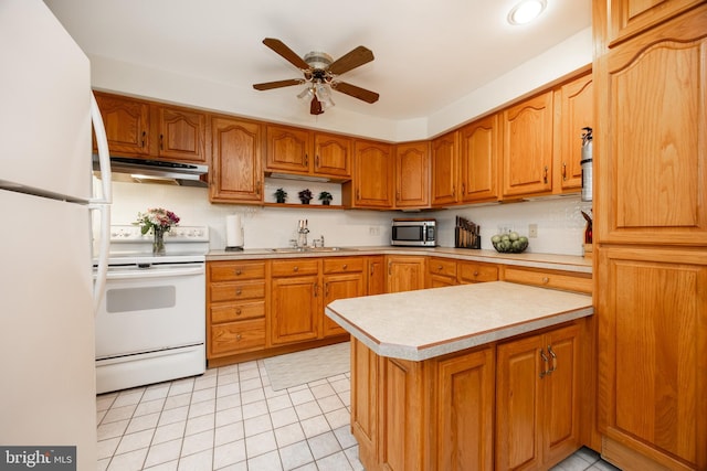 200 Maplewood Dr Unit 20, Pottstown, PA 19464 - kitchen with white appliances, under cabinet range hood, a sink, light countertops, and a ceiling fan