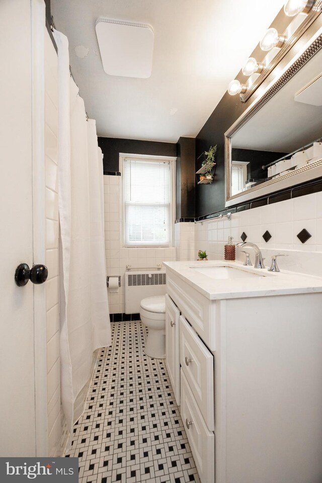 200 Maplewood Dr Unit 20, Pottstown, PA 19464 - bathroom featuring radiator, tile walls, toilet, vanity, and a shower with shower curtain