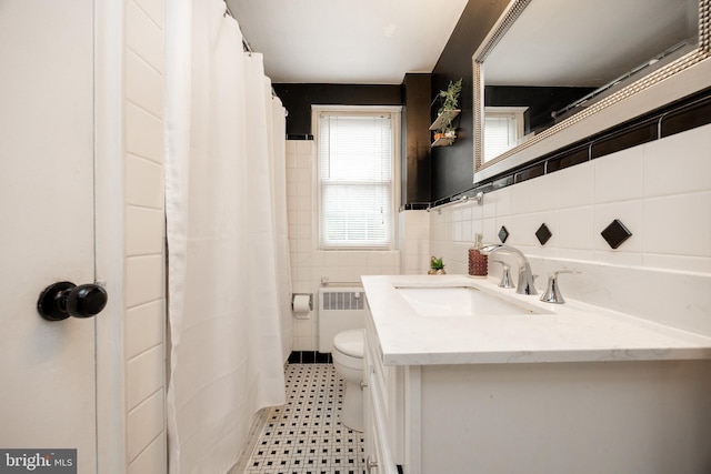 200 Maplewood Dr Unit 20, Pottstown, PA 19464 - full bath featuring radiator heating unit, tile walls, vanity, toilet, and tile patterned floors
