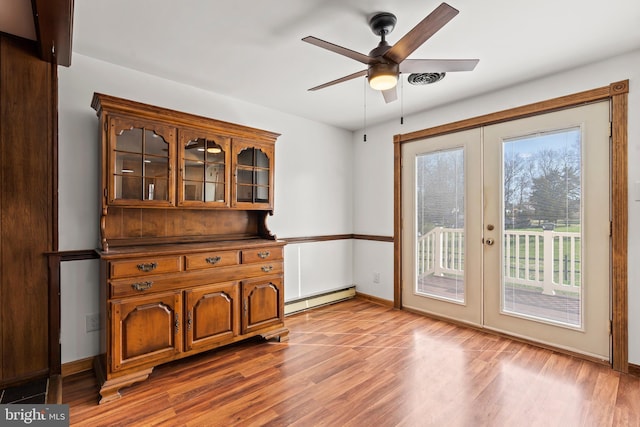 18000 Davis Ln, Boonsboro, MD 21713 - unfurnished dining area with baseboard heating, french doors, wood finished floors, and a ceiling fan