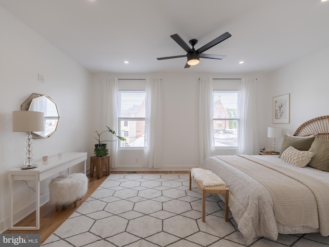 bedroom featuring light wood-style flooring, recessed lighting, a ceiling fan, and baseboards