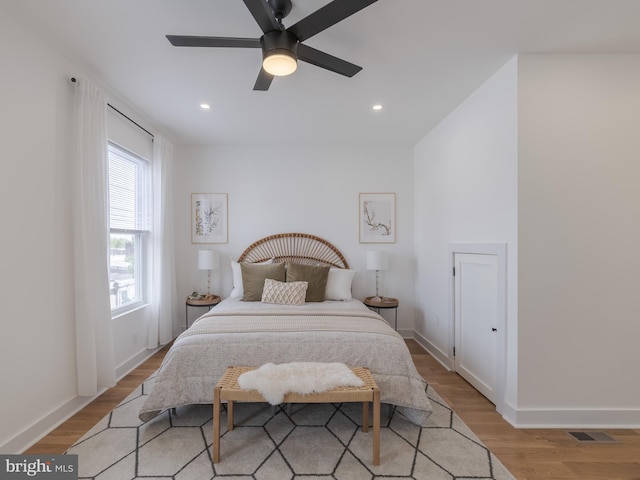 bedroom with light wood-type flooring, baseboards, recessed lighting, and ceiling fan