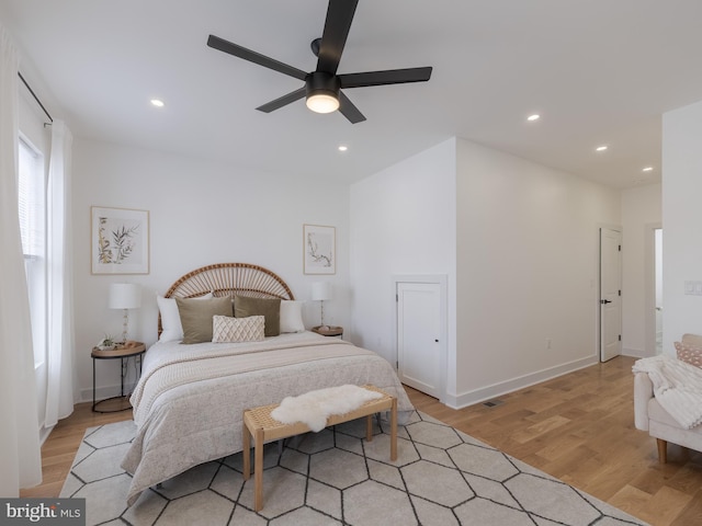 bedroom with light wood-style floors, recessed lighting, ceiling fan, and baseboards