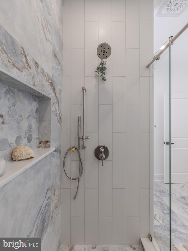 bathroom with tiled shower