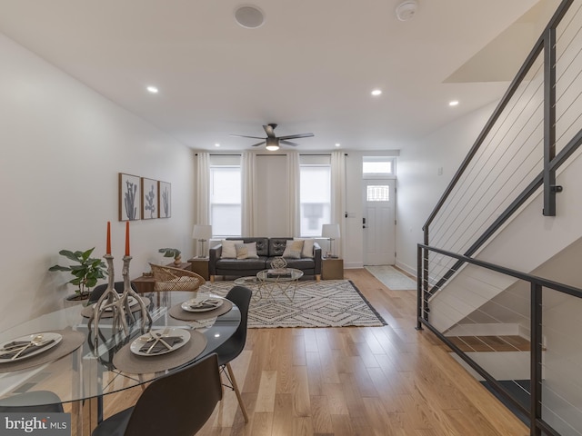 living area featuring plenty of natural light, stairs, light wood finished floors, ceiling fan, and recessed lighting