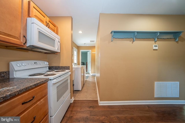 5330 Birney Hwy, Aston, PA 19014 - kitchen with white appliances, washer and dryer, dark wood-type flooring, baseboards, and recessed lighting