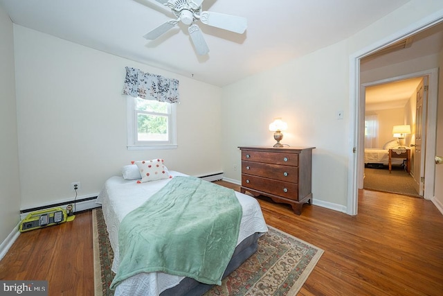 5330 Birney Hwy, Aston, PA 19014 - bedroom featuring wood finished floors, baseboard heating, baseboards, and a ceiling fan