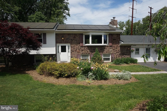 1331 Bradley Ave, Hummelstown, PA 17036 - view of front facade featuring stone siding, a chimney, and a front yard
