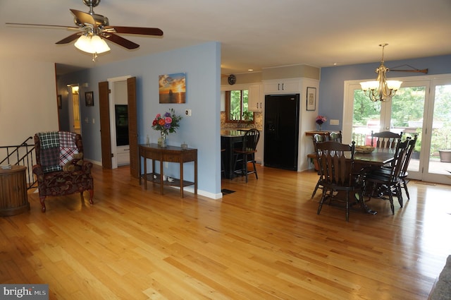 1331 Bradley Ave, Hummelstown, PA 17036 - dining space featuring light wood-type flooring, a chandelier, and a ceiling fan