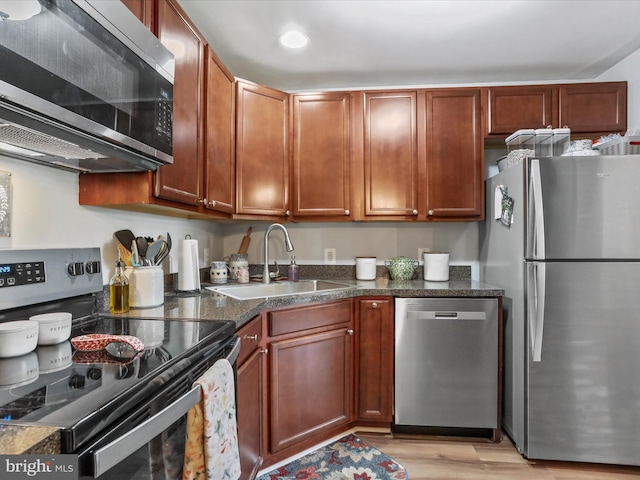 108 Timberlake Ter Unit 7, Stephens City, VA 22655 - kitchen featuring stainless steel appliances, a sink, light wood-style flooring, and dark stone counters
