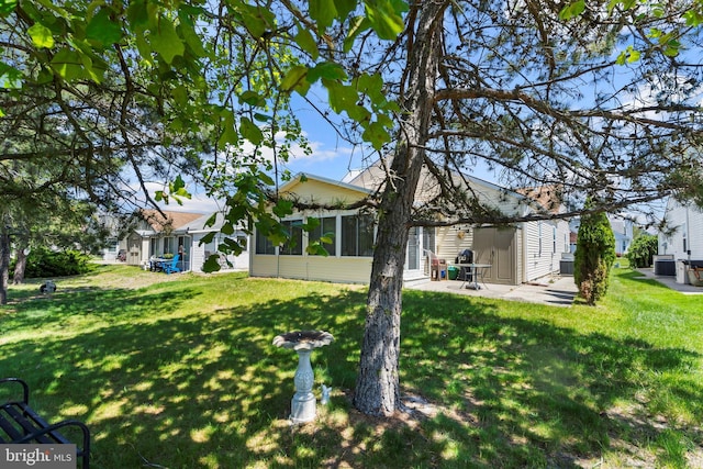 53 Stockport Dr, Toms River, NJ 08757 - view of green lawn with a patio area and a sunroom