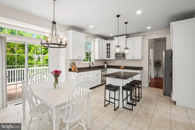 56 Thackery Ct, Sewell, NJ 08080 - kitchen featuring stainless steel appliances, tasteful backsplash, a chandelier, white cabinetry, and a kitchen bar