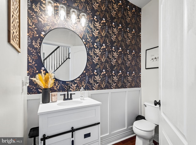 56 Thackery Ct, Sewell, NJ 08080 - bathroom with wallpapered walls, wainscoting, toilet, vanity, and wood finished floors