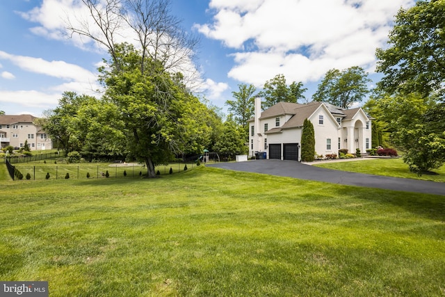 56 Thackery Ct, Sewell, NJ 08080 - view of front of property with an attached garage, driveway, a chimney, solar panels, and stucco siding