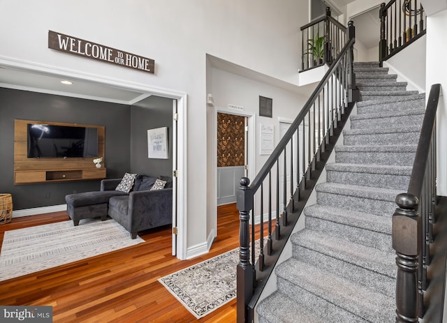 56 Thackery Ct, Sewell, NJ 08080 - foyer entrance with wood finished floors, stairway, a towering ceiling, and baseboards