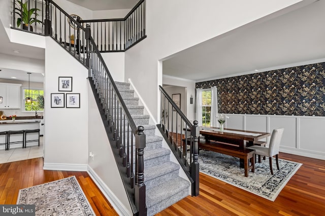 56 Thackery Ct, Sewell, NJ 08080 - stairs featuring hardwood / wood-style flooring, ornamental molding, a wainscoted wall, and baseboards