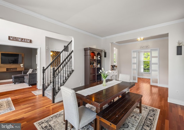 56 Thackery Ct, Sewell, NJ 08080 - dining area featuring wood-type flooring, stairs, baseboards, and ornamental molding