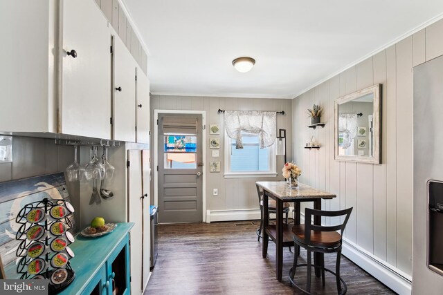 406 Myrtle St, Crisfield, MD 21817 - dining space featuring a baseboard radiator, crown molding, dark wood-type flooring, a baseboard heating unit, and baseboards
