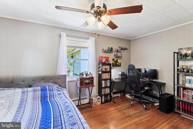 406 Myrtle St, Crisfield, MD 21817 - bedroom with wood finished floors, crown molding, an office area, a ceiling fan, and baseboard heating