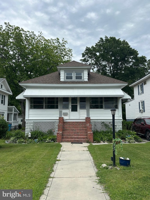 406 Myrtle St, Crisfield, MD 21817 - view of front of house featuring a front lawn, roof with shingles, and entry steps