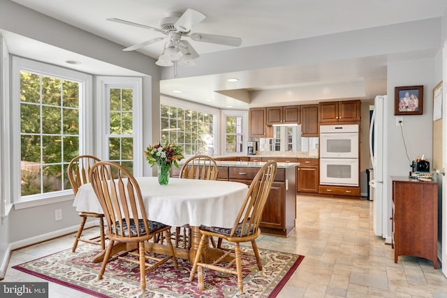8314 Graceway Dr, Lorton, VA 22079 - dining space featuring healthy amount of natural light, recessed lighting, baseboards, ceiling fan, and a tray ceiling