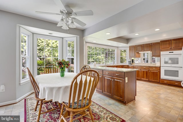 8314 Graceway Dr, Lorton, VA 22079 - dining area with healthy amount of natural light, stone tile flooring, recessed lighting, and ceiling fan
