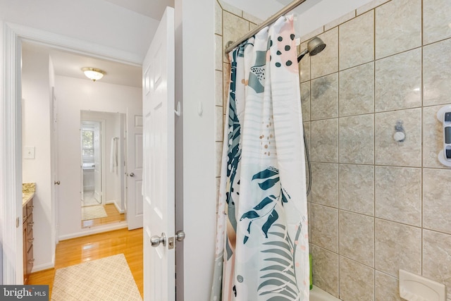 8314 Graceway Dr, Lorton, VA 22079 - bathroom with wood finished floors, vanity, and shower / bath combo with shower curtain