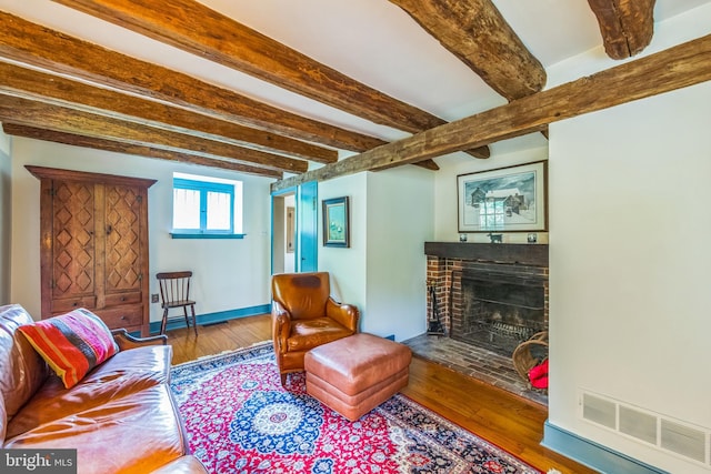 615 Westbourne Rd, West Chester, PA 19382 - living room with a brick fireplace, hardwood / wood-style floors, beamed ceiling, and baseboards