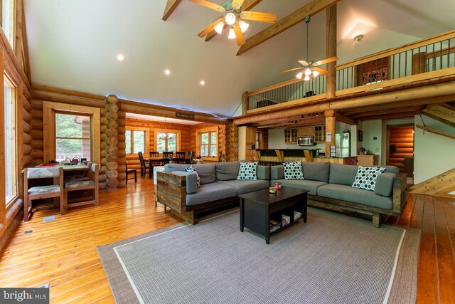969 Hoyes Run Rd, Oakland, MD 21550 - living area with high vaulted ceiling, log walls, a ceiling fan, hardwood / wood-style flooring, and stairway