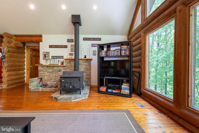969 Hoyes Run Rd, Oakland, MD 21550 - living room featuring log walls, a wood stove, plenty of natural light, hardwood / wood-style flooring, and recessed lighting